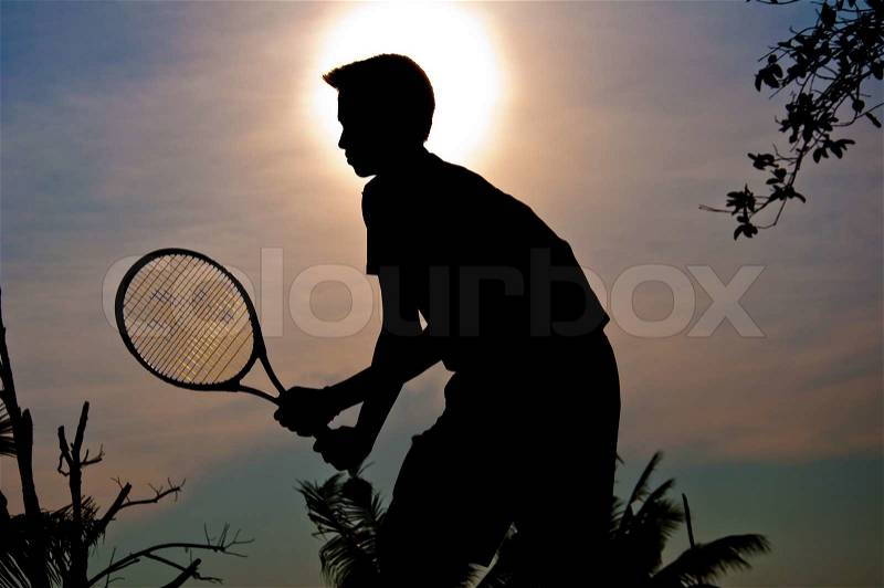 Silhouette of man play tennis in the field, stock photo