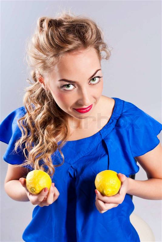 Portrait of young beauty woman with lemon, stock photo