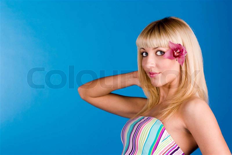 Cute blonde with an orchid in her hair, stock photo