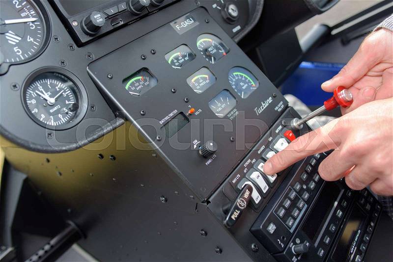 Man manipulating controls in cockpit, stock photo