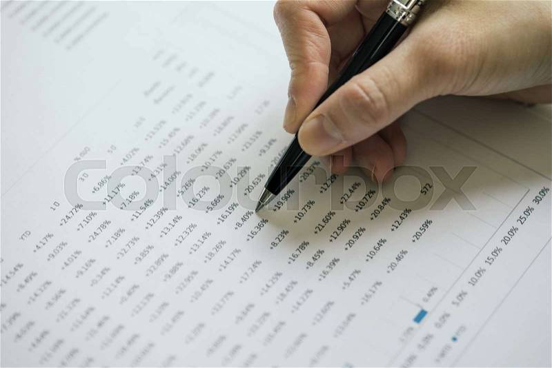 Close up of hand holding black pen on number or percentage yield of financial investment return year to date, interest compound or growth of money concept, stock photo