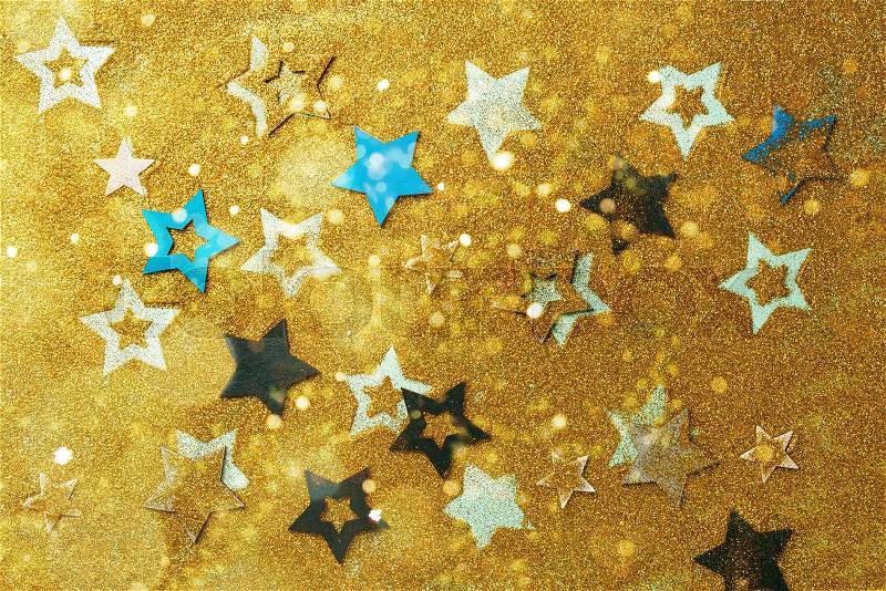 Blue, yellow stars on gold background with bokeh. Texture for new year, birthday, baby shower party. Creative pattern. Banner, stock photo