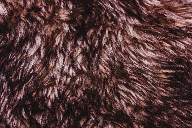 Brown dark warm faux fur texture. Animal wildlife concept, stock photo