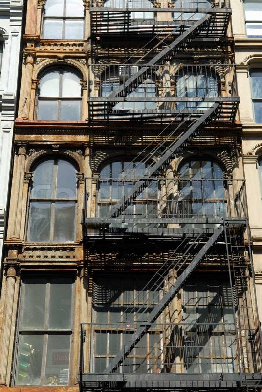 Old building with fire ladder, New York City, stock photo