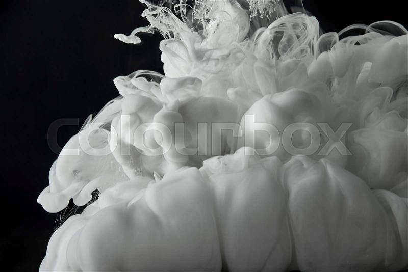 White paint splash in water on black background, stock photo