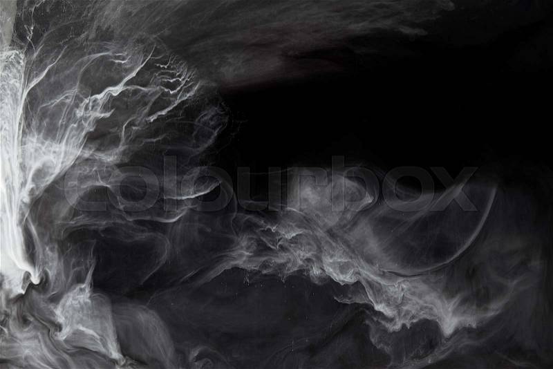 Abstract swirls of grey paint on black background, stock photo