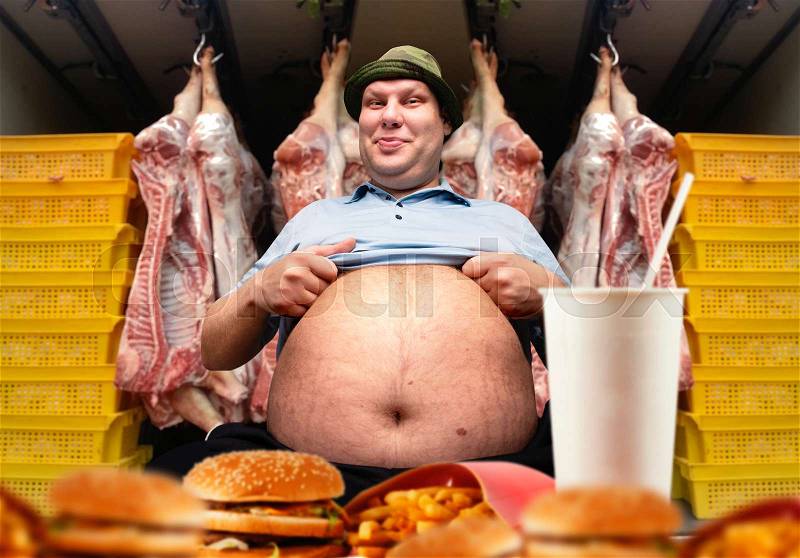 Happy fat man and fast food, pork carcasses on background. Overweight people, burgers eating, stock photo