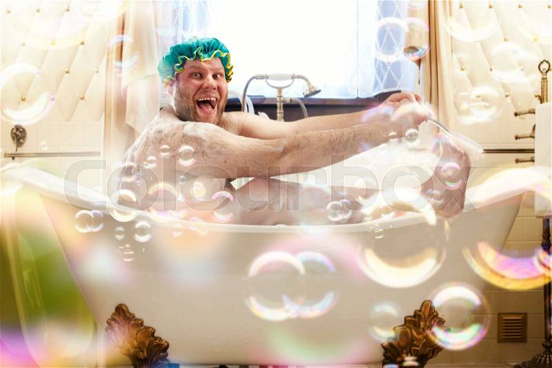 Fat ugly man washing in a bath. Bizarre male person laughing in bathroom, stock photo