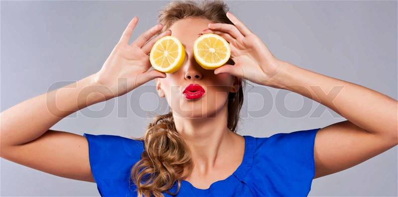 Portrait of woman, holding fresh lemon, stock photo