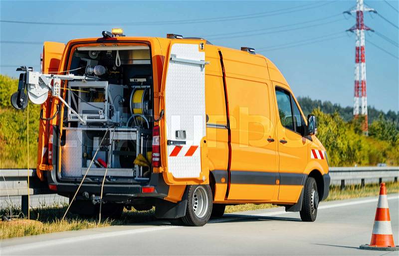Mini van with cable to do road works in Poland, stock photo