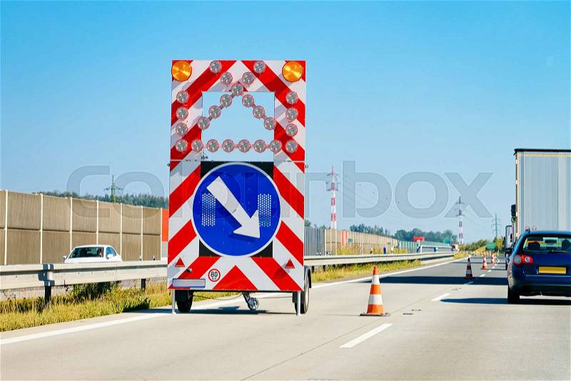Arrow down right reflective direction road sign in highway in Poland, stock photo
