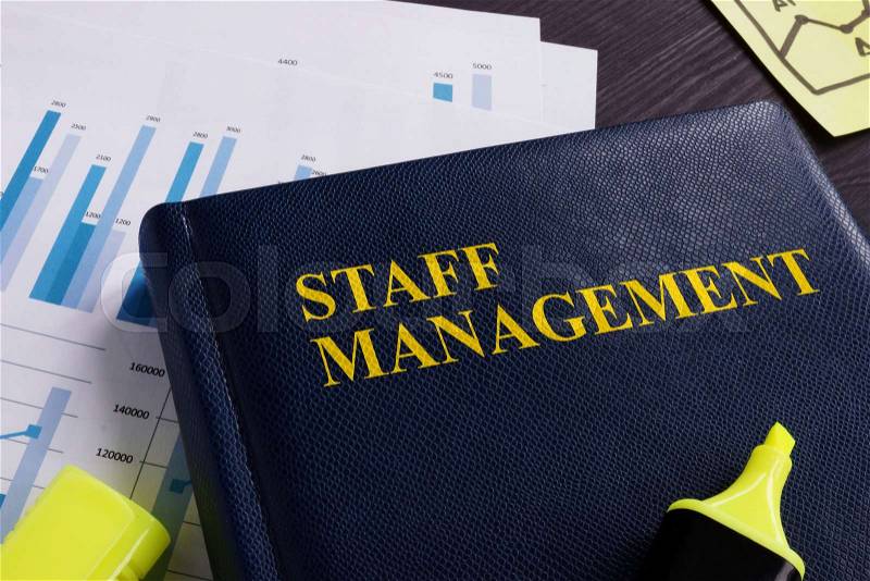 Staff management book and documents on a desk, stock photo