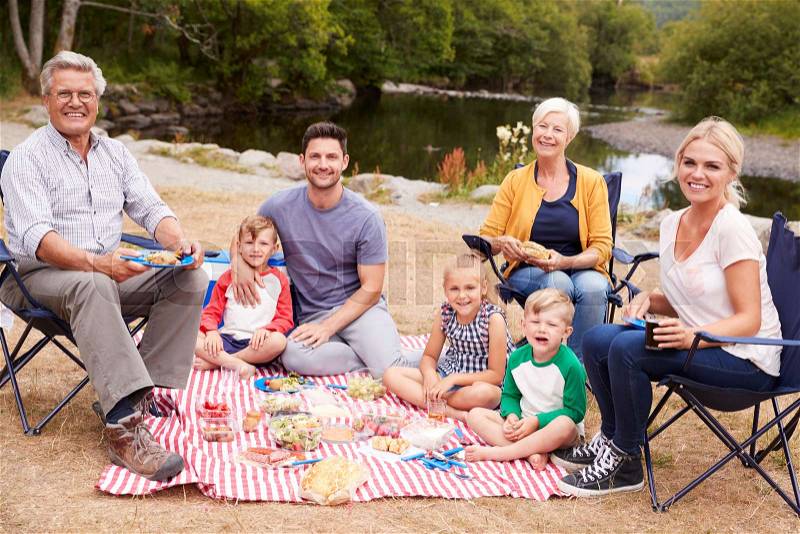 Portrait Of Multi Generation Family Enjoying Picnic In Countryside, stock photo