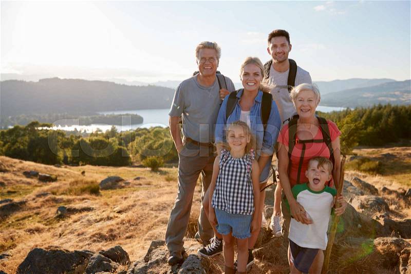 Portrait Of Multi Generation Family Standing At Top Of Hill On Hike Through Countryside In Lake District UK, stock photo