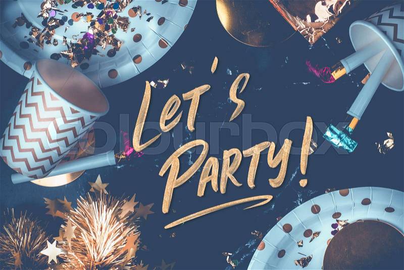 Lets party hand brush stroke font on marble table with party cup,party blower,tinsel,confetti.Fun Celebrate holiday party time table top view.blue modern tone ..., stock photo