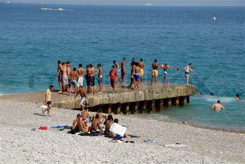 Young people having fun on the beach of Nice, France, stock photo