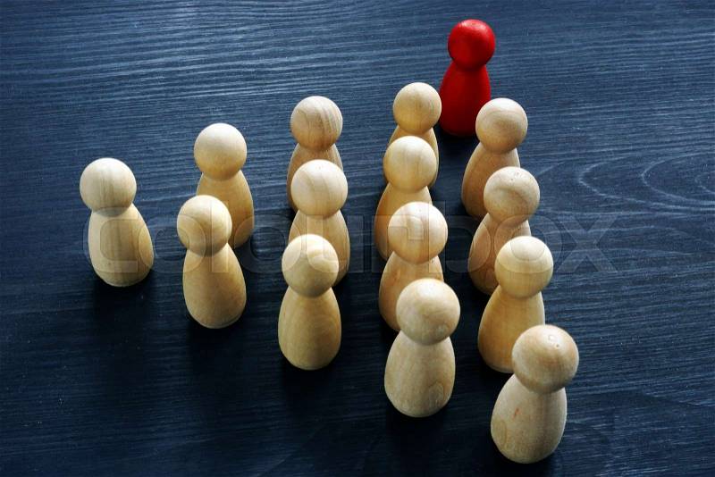 Teamwork in business and leadership concept. Wooden figures on the desk, stock photo