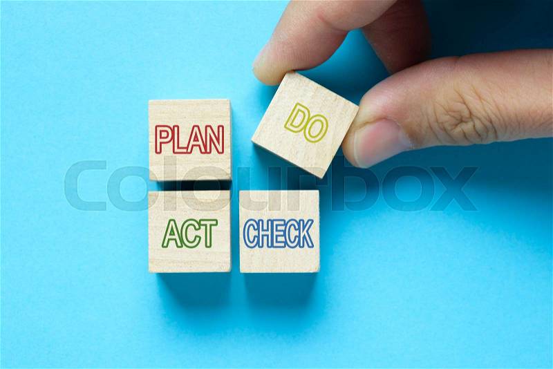 Plan Do Check Act cycle diagram on wood cubes, stock photo