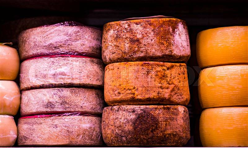 Heads of cheese on the shelf in the shop on the market, stock photo