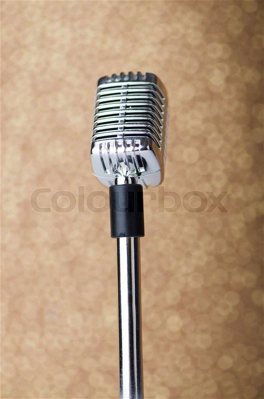 Old vintage microphone on background, stock photo