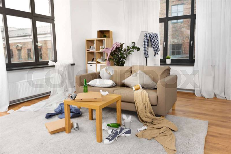 Mess, disorder and interior concept - view of messy home living room with scattered stuff, stock photo