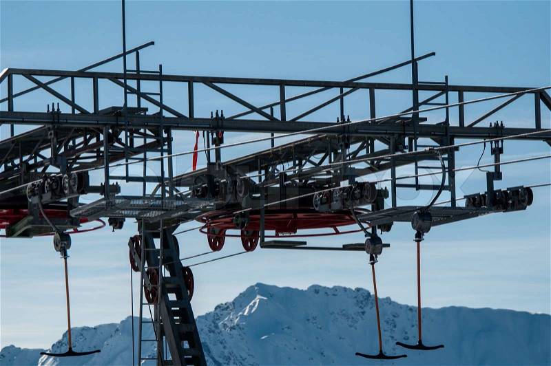 Detail of T-bar ski lift drag lift against great bkue sky, stock photo
