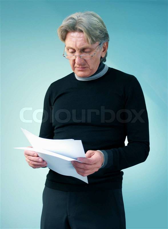 Senior man reading important papers. Attractive seniors lifestyle in studio uniform background series, stock photo