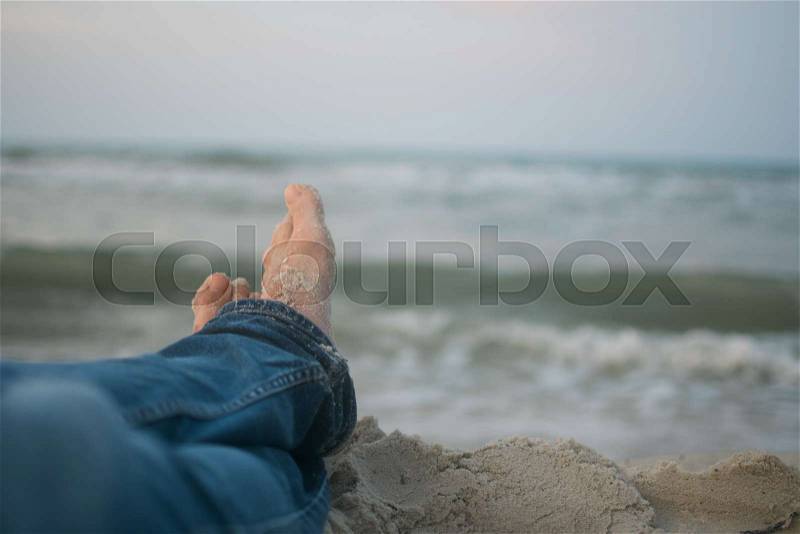 Sandy feet on the beach, stock photo