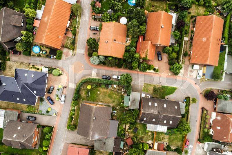 Vertical view from the air with vertical view of houses, roofs and streets of a village in northern Germany, stock photo
