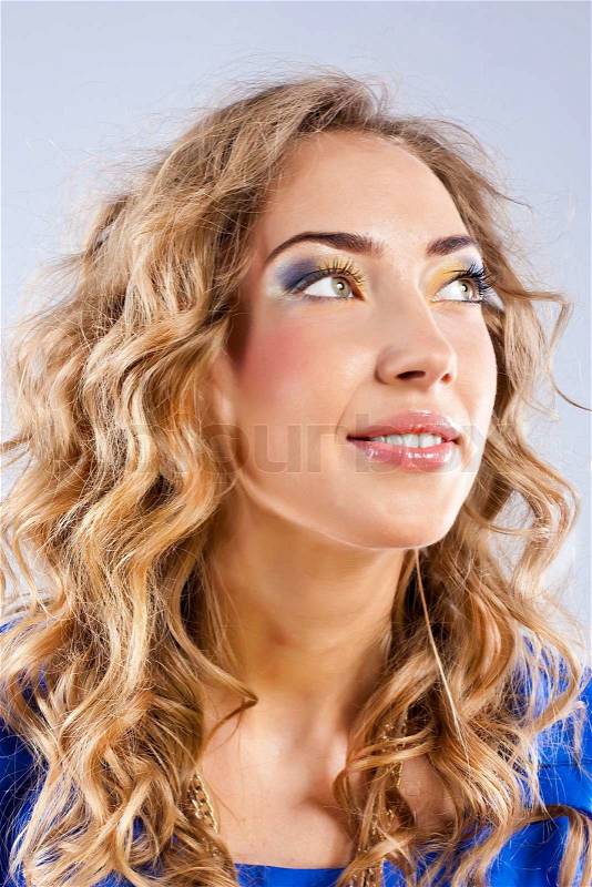 Curly blonde with bright makeup, stock photo