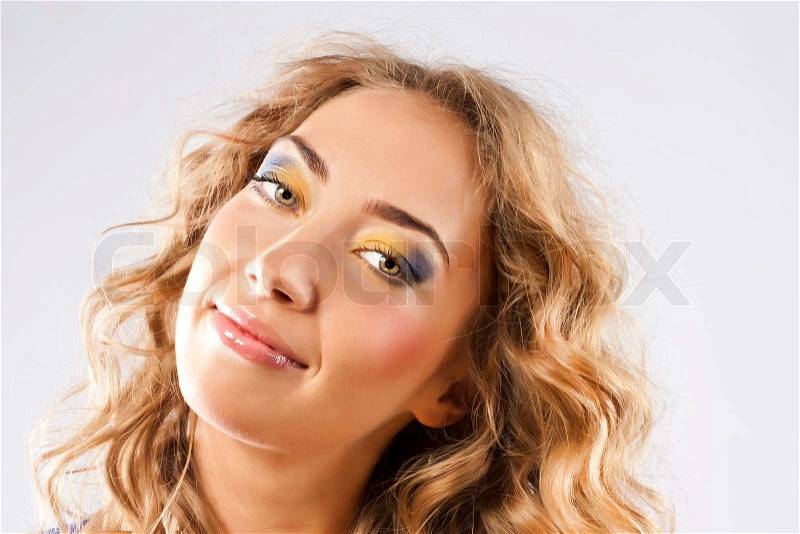 Curly blonde with bright makeup, stock photo