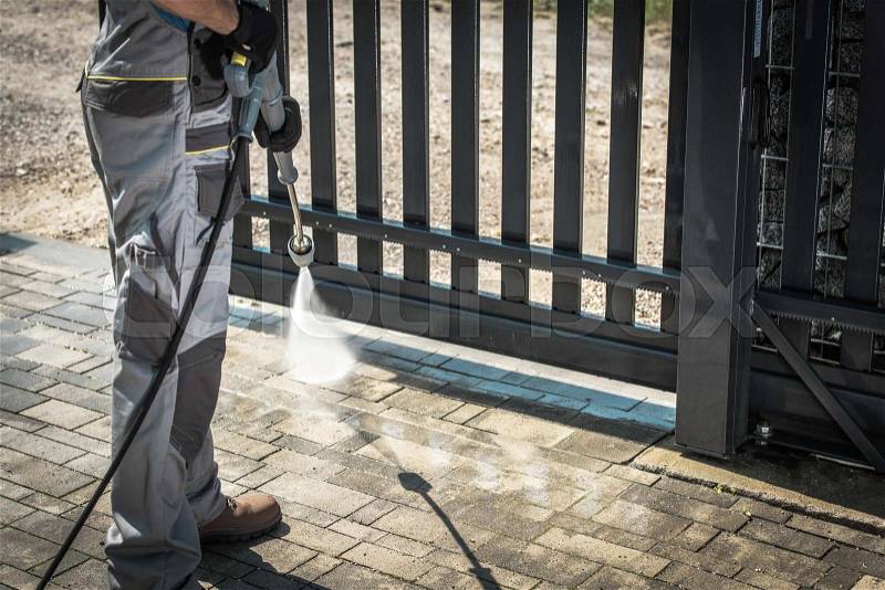 Driveway and a Gate Pressure Washing. Cleaning House Surroundings, stock photo