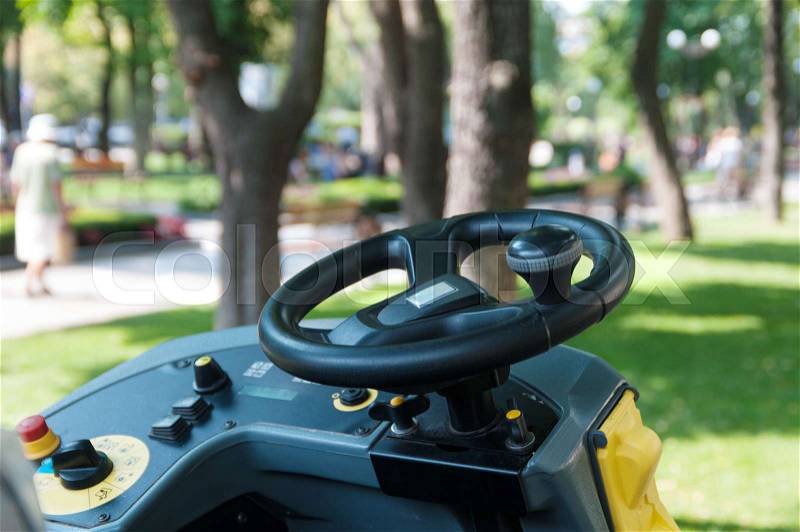 Sidewalk cleaning machine in the park close-up, stock photo
