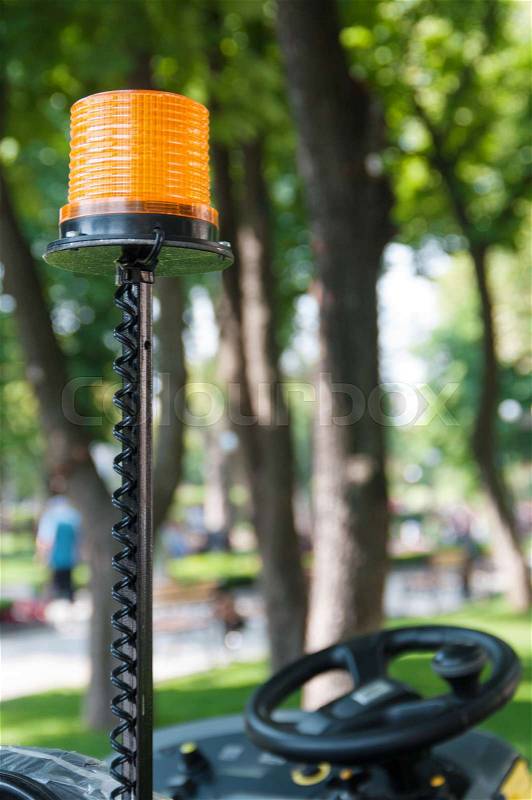Signal lamp car for cleaning the sidewalk in the park close-up, stock photo