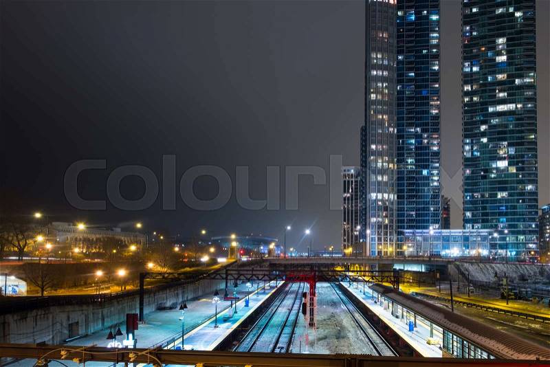 Chicago Museum Campus train Station in winter evening with bright public lights and luxury apartment tower in the background, stock photo