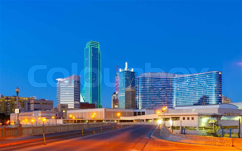 Downtown Dallas skyline at night with illuminated glass buildings seen from Houston Street, stock photo