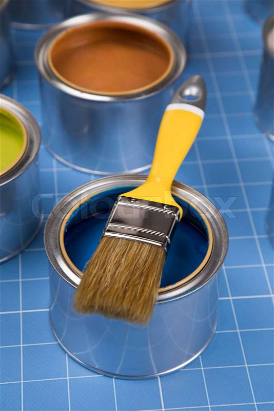 Open cans of paint,Brush, blue background, stock photo