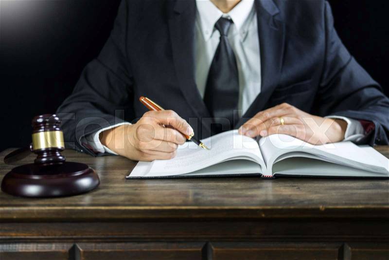 Justice and law concept.Male judge in a courtroom working on wood table with documents., attorney court judge justice gavel legal legislation concept, stock photo