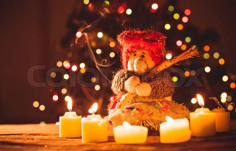 Old ugly woman - fortune teller with candles on Christmas, handmade toy, stock photo