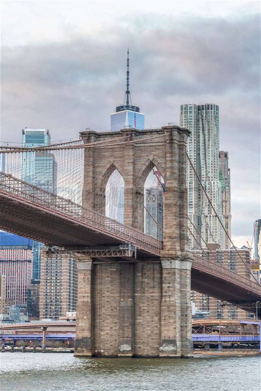 Brooklyn Bridge at sunset from cruise ship with Lower Manhattan buildings, New York City, stock photo