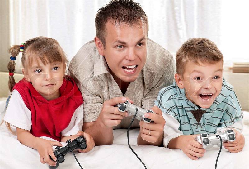 Happy family playing a video game, stock photo