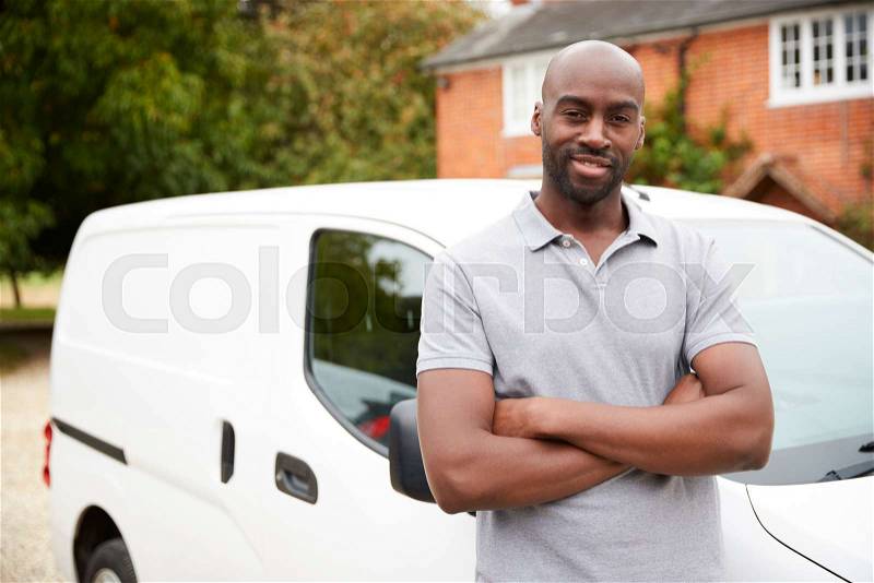 Young black adult tradesman standing next to his white van, close up, close up, stock photo