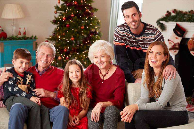 Portrait Of Multi Generation Family Sitting On Sofa In Lounge At Home On Christmas Day, stock photo
