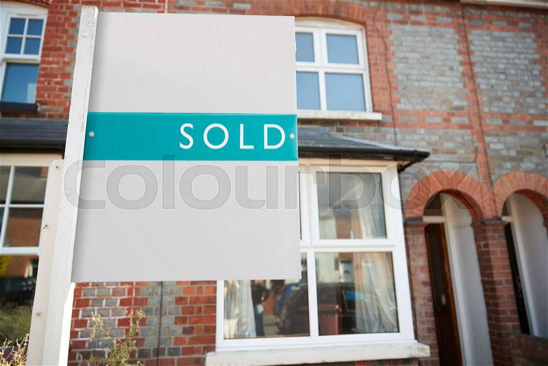 Real Estate Sold Board Outside Terraced House, stock photo