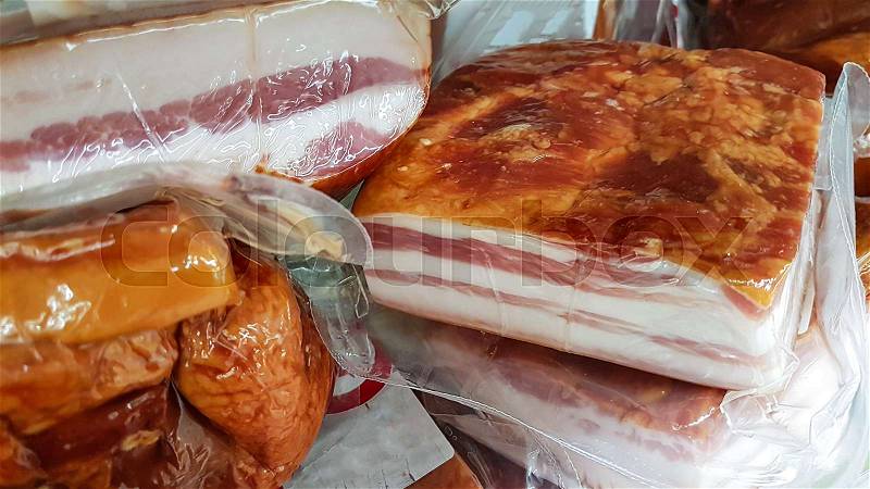 Concept of unhealthy food - processed meat packed in a plastic for sale in a large supermarket in close-up, stock photo