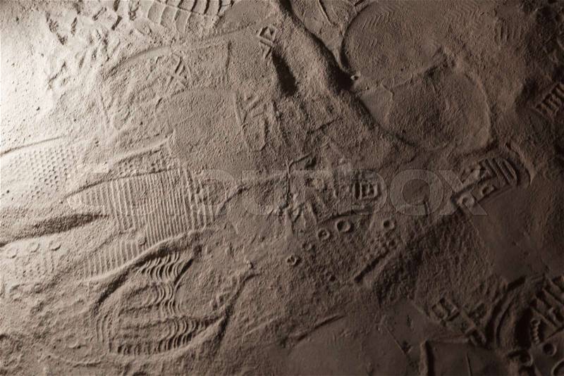 Footprints in dark gray dusty ground, background photo texture, stock photo