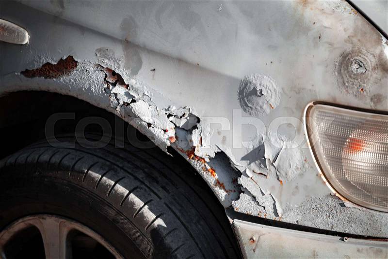Damaged old front car wing with rust and scratches, close-up photo, stock photo