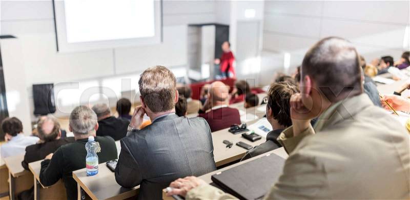 Speaker giving a talk in conference hall at business event. Audience at the conference hall. Business and Entrepreneurship concept. Focus on unrecognizable people in ..., stock photo
