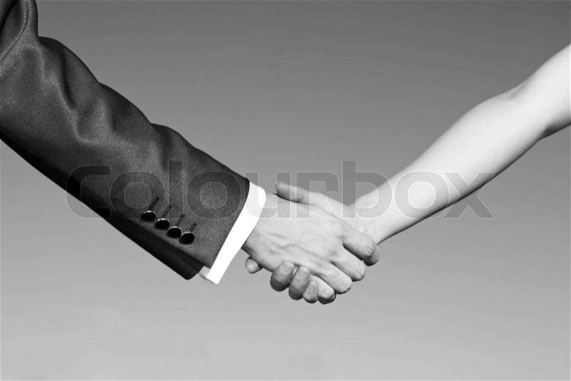 Shaking hands of two business people, stock photo