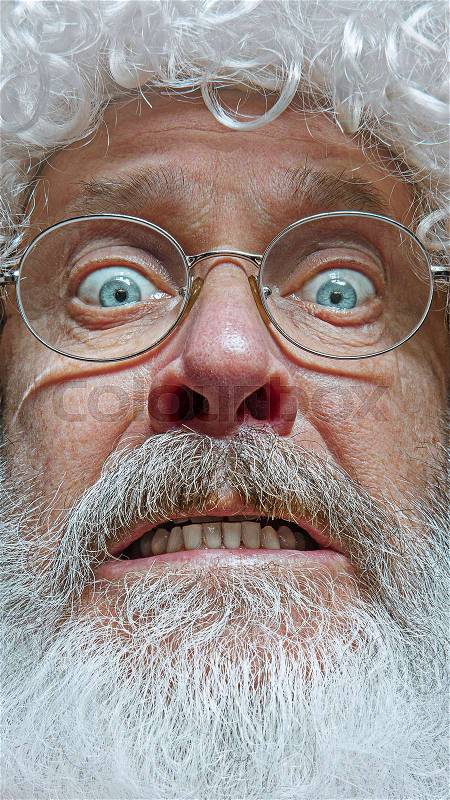 Santa Claus with surprised expression. Christmas celebration concept. The emotional face of Santa Clause in glasses. The holiday, expression, emotions, senior, ..., stock photo
